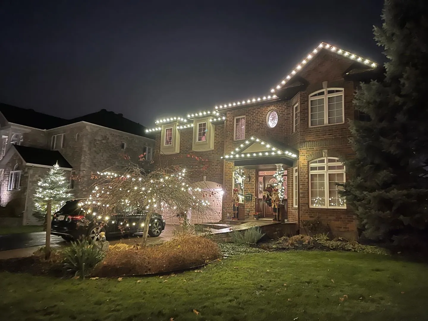 Large home with warm white holiday lights