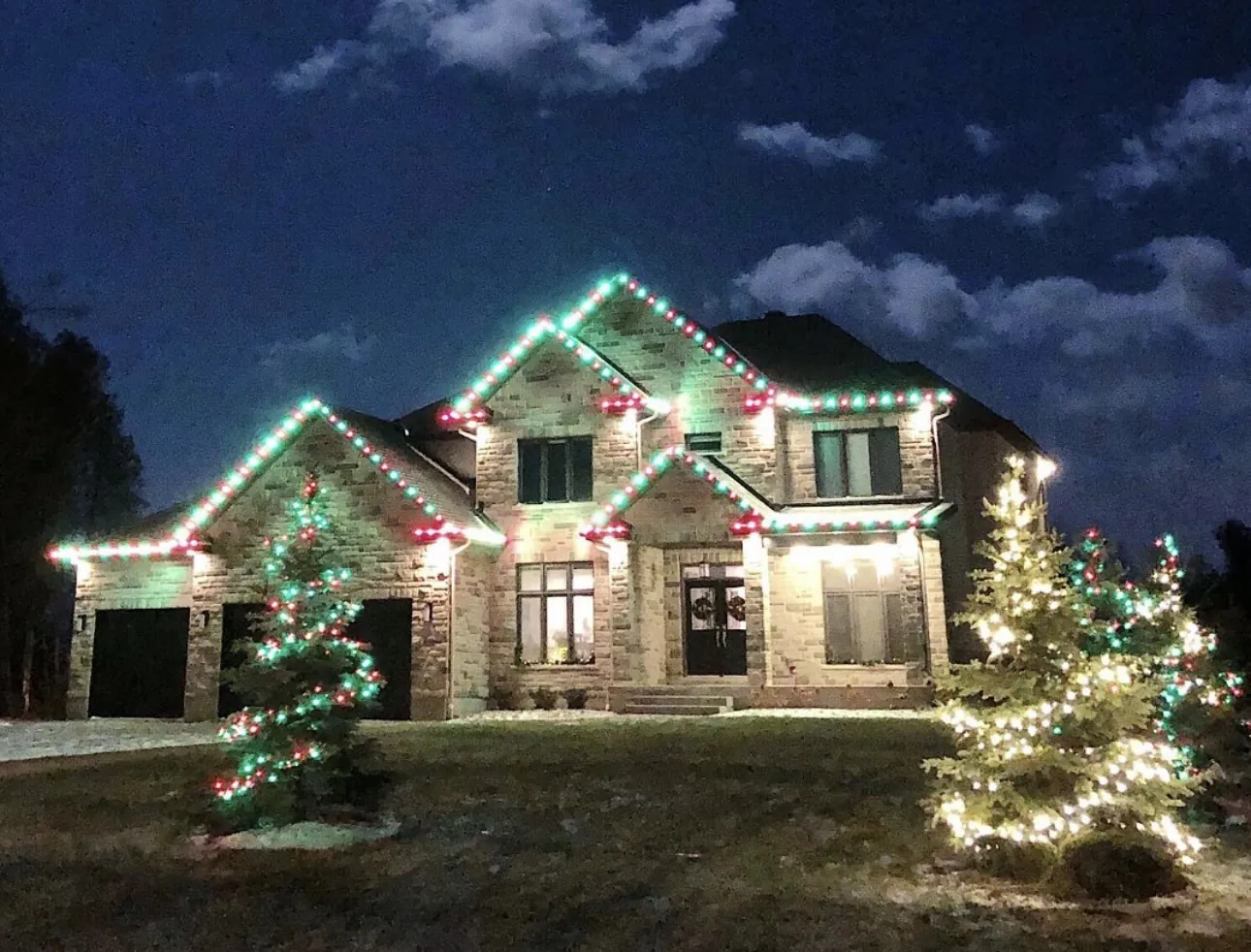 Red and green lights tracing a home's roofline